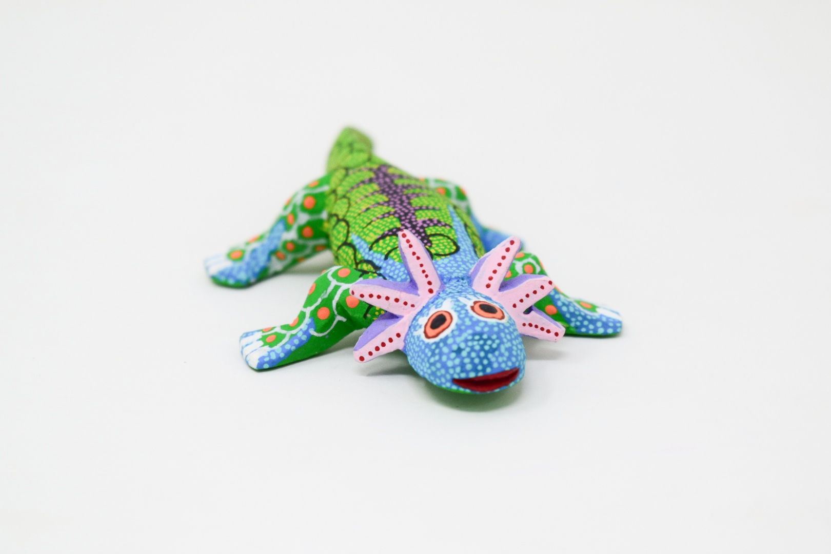 A colorful hand-painted Mexican folk art Axolotl figurine.