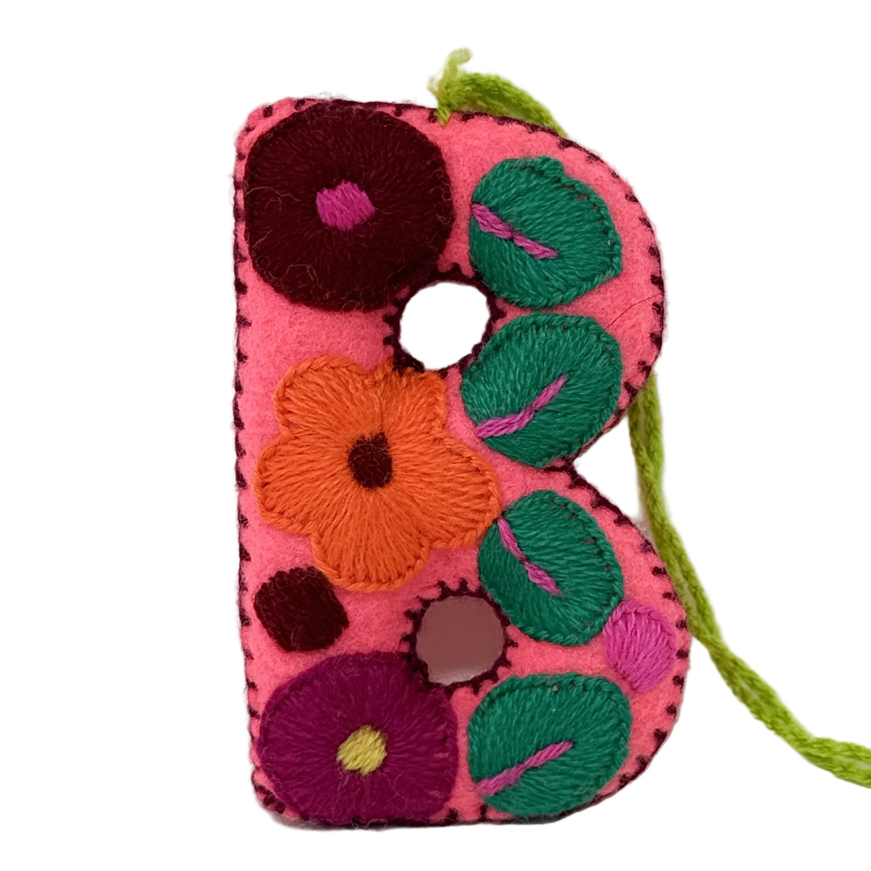 A handmade felt letter 'B' ornament or wall hanging in bright pink, decorated with colorful.