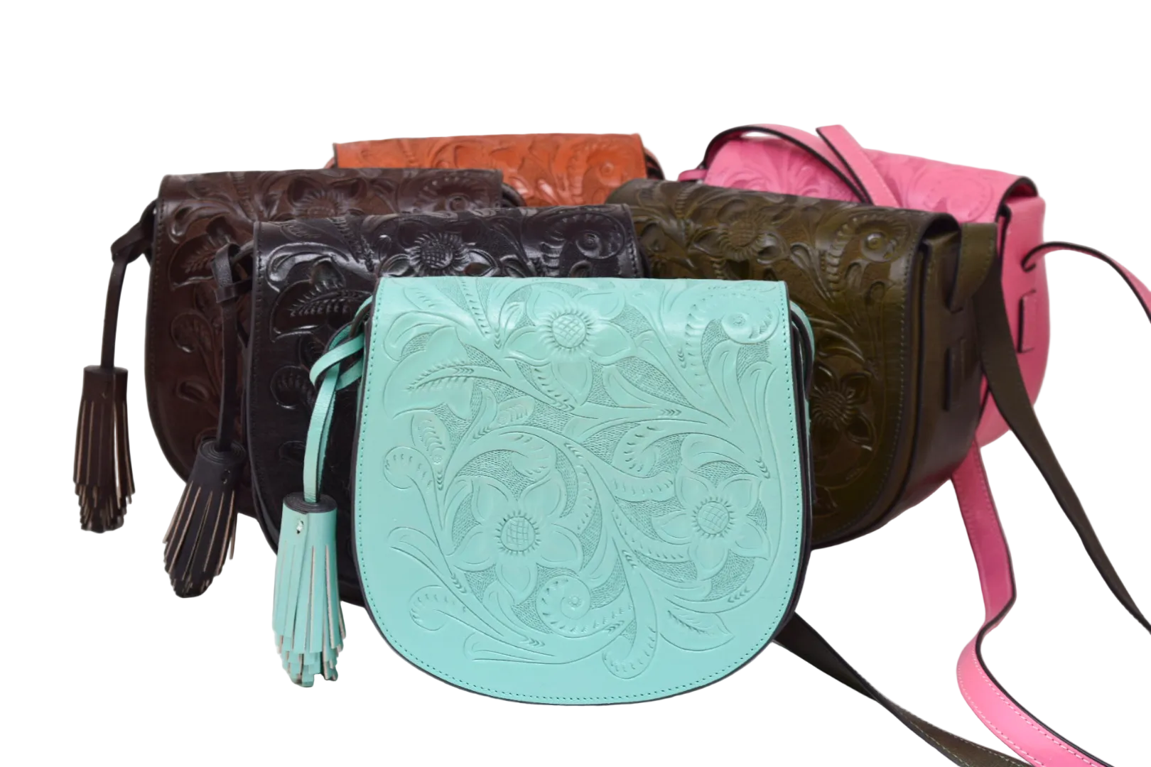 A group of tooled leather shoulder bags and a clutch arranged on a white studio background. The front-most bag is a light aqua/mint color with floral tooling and a tassel.