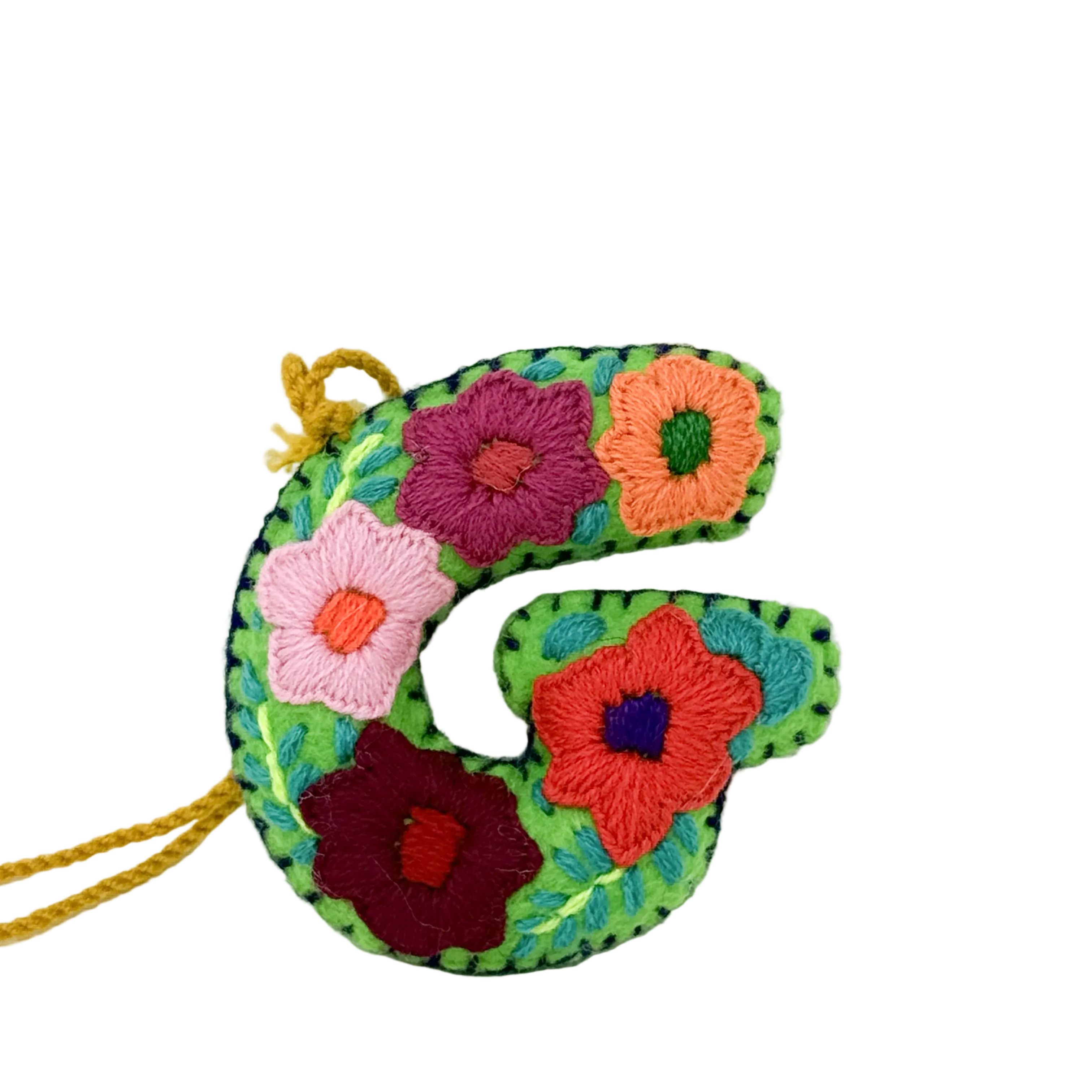 A handmade embroidered letter 'G' ornament.